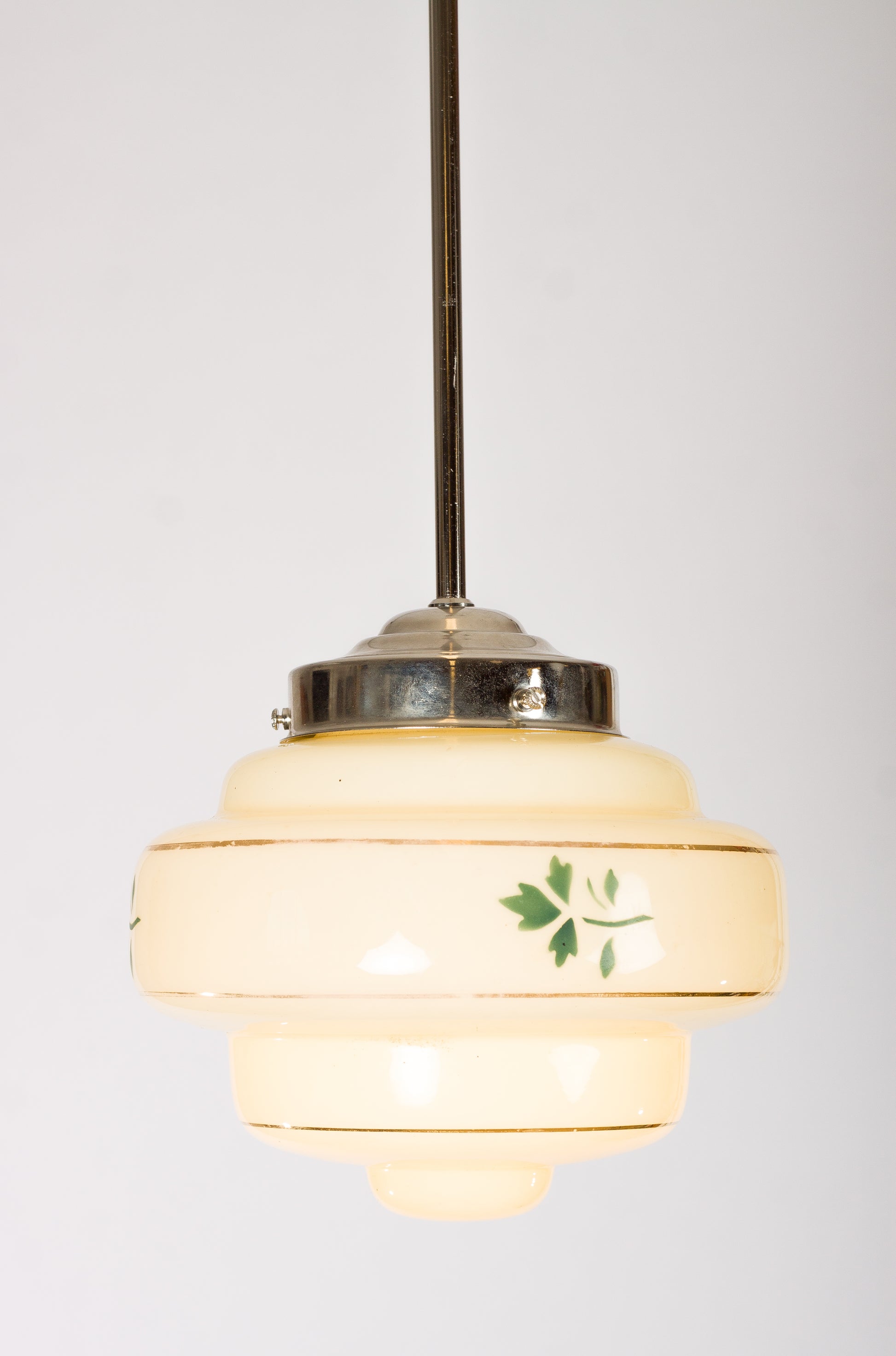 Lampkupa i krämfärgat glas med guldränder och grön lövdekor. 1940-talsdesign
