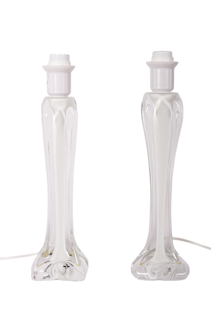 Par eleganta bordslampor i vitt och genomskinligt glas från Flygfors, designade av Paul Kedelv för Modighus.se.