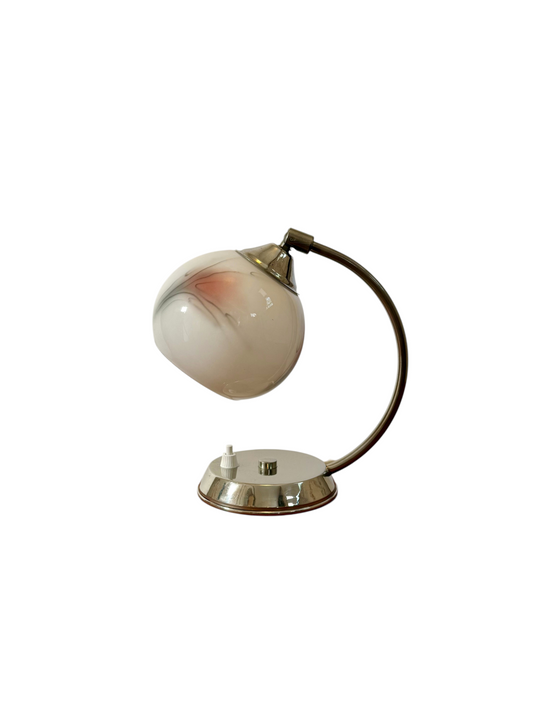 Modighus.se vintage bordslampa i krom med vit glaskupa och rödsvart dekor, placerad på en träyta.