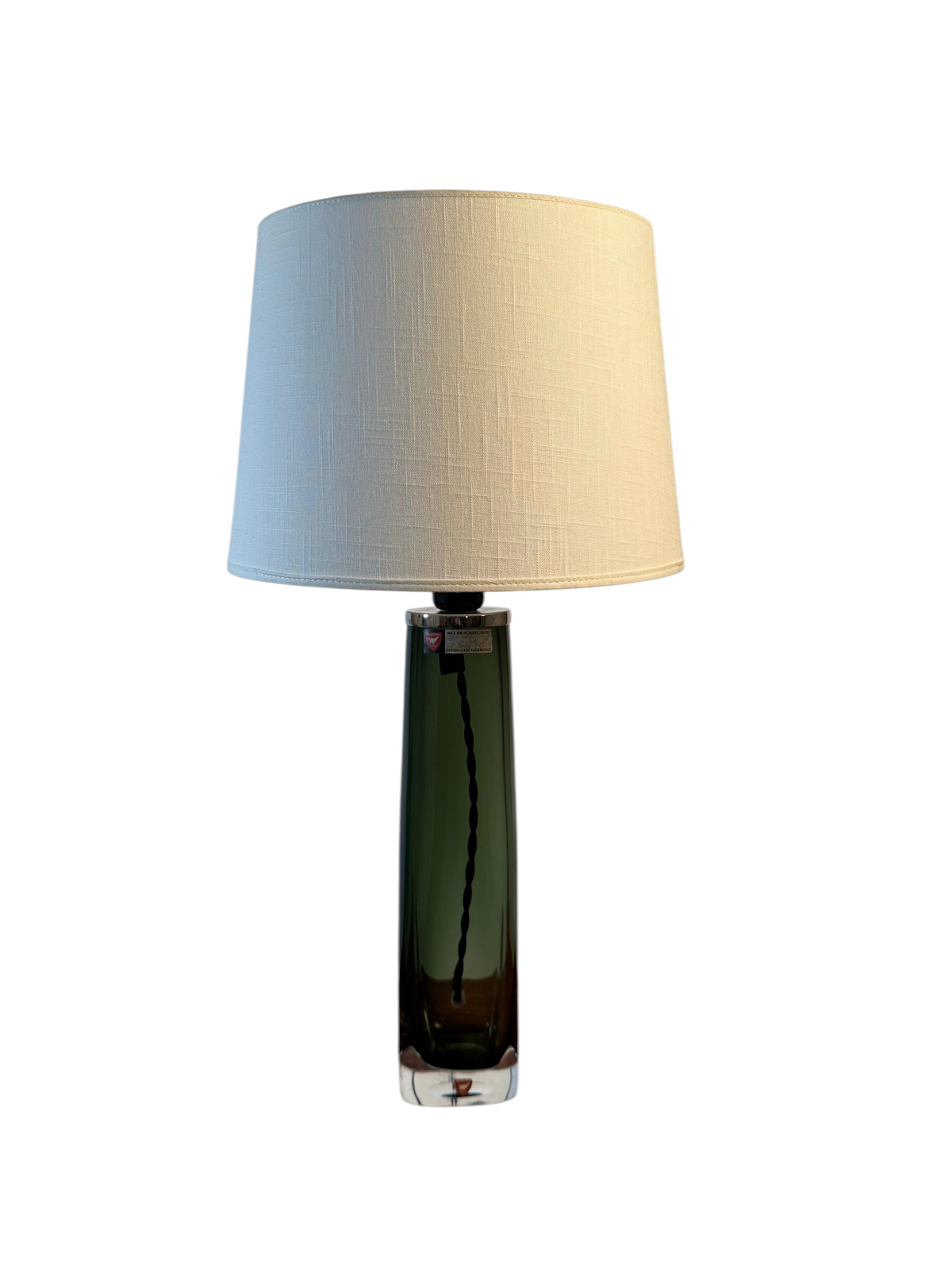 Modighus.se Orrefors bordslampa i grönt glas designad av Carl Fagerlund med beige tygskärm och svart textilkabel